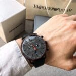 Montre Emporio Armani Aviator AR11168 noire et grise portée au poignet d'un homme au Maroc.