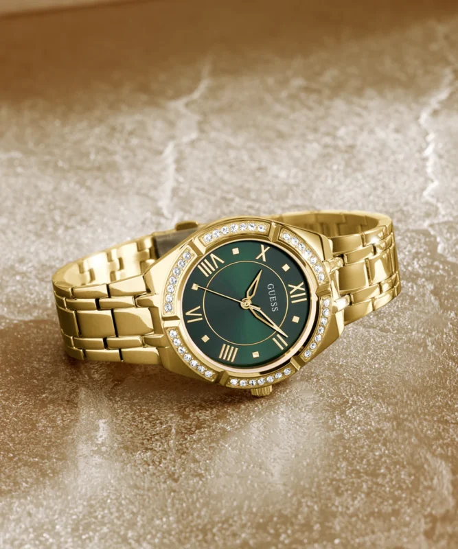 a gold watch with a green face