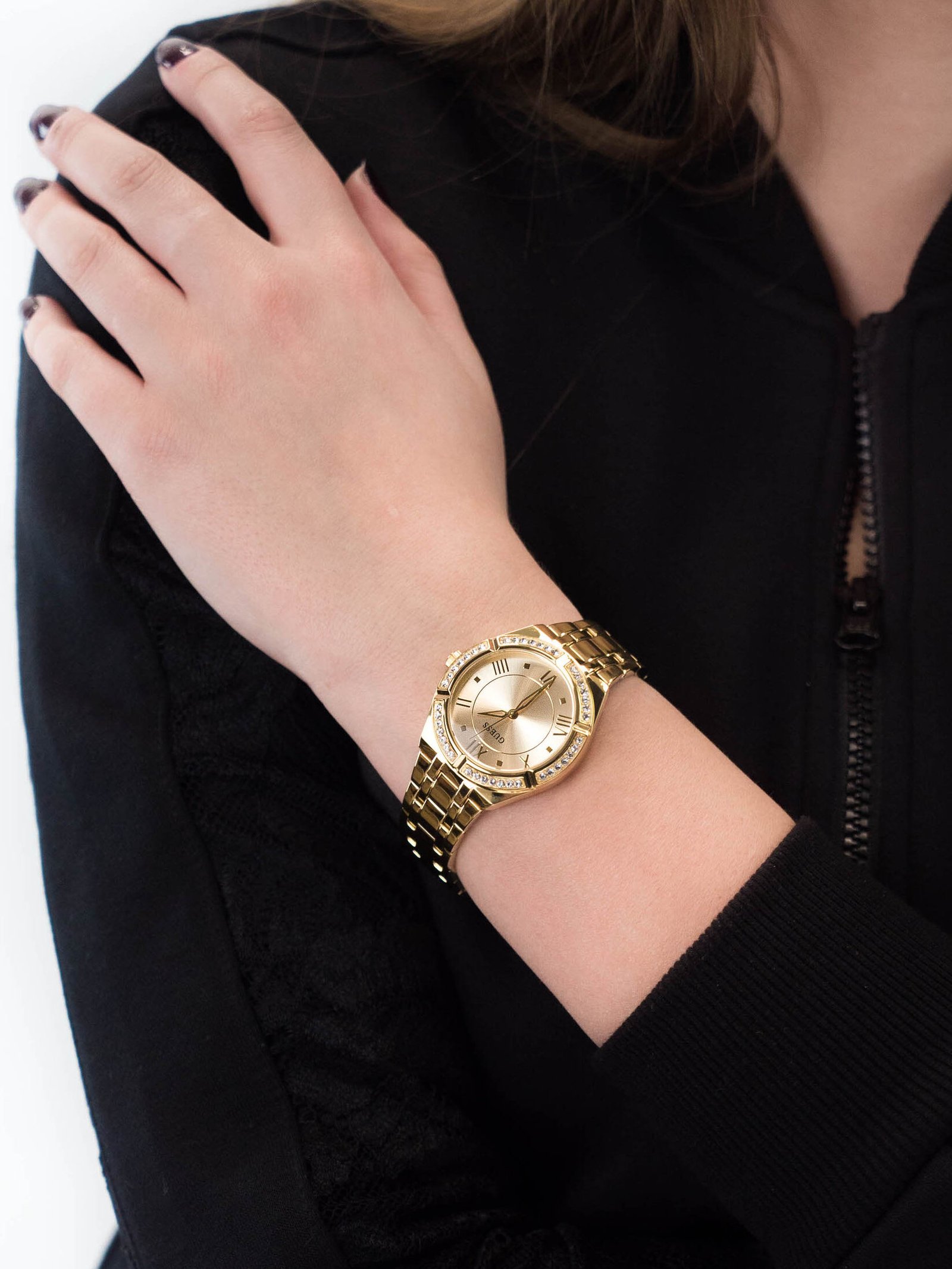 a person wearing a gold watch