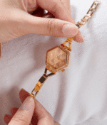 Montre Guess femme hexagonale or rose GW0680L3 tenue en main, montrant les détails au Maroc.