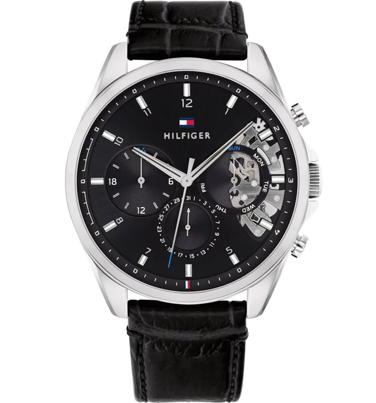 Montre Tommy Hilfiger Homme 1710449 Cadran noir avec détails squelette argentés, logo drapeau tricolore, index luminescents, sous-cadrans date et jour, bracelet cuir croco noir