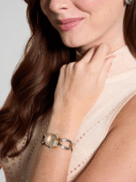 Montre-bijou GUESS GW0683L6 bicolore avec cristaux portée avec élégance au poignet d'une femme.